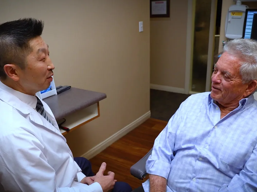 Dr. Lee sits down with a patient to talk