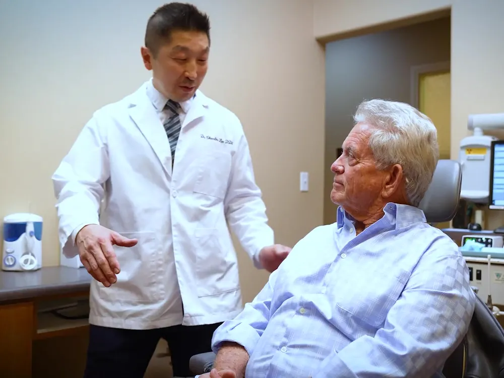 Dr. Lee greets a patient in the treatment room