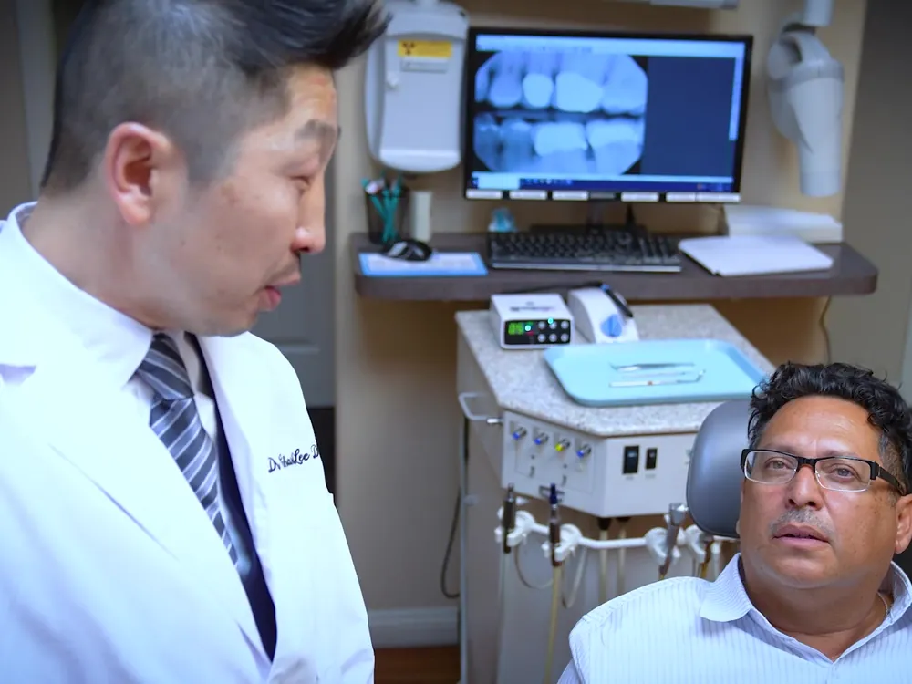 A patient listens as Dr. Lee explains